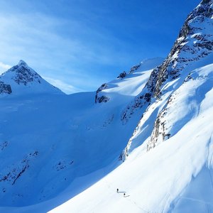 Skiers leading the way up Aniversery Glacier between Mount Joffree and Mount Matier.