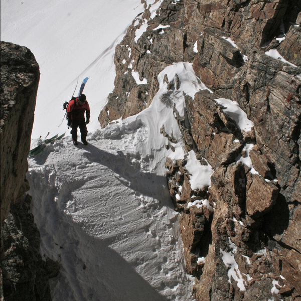 Ryan N. looking down a tracked out couloir.
