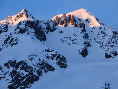 The summit of 8100 just touched by the sun. SXSW is the couloir directly below the summit. Note the rock and other glacial hazards below the line.