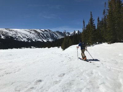 A friend slides along the north shore of Long Lake. Even with the peaks coming closer into view, pace yourself.