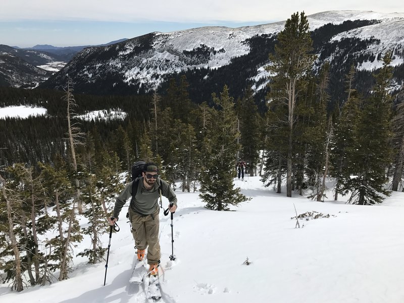 Trudging up the ridge through wet spring snow. Way in the background, on the left side, sits a few of Boulder's foothills; Sanitas, Flagstaff, and Green Mountain.
