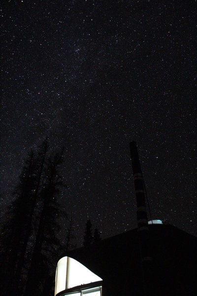 A bright milky way shines over the Colorado Trail Yurt.
