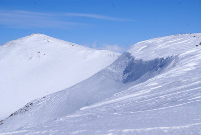 A cornice seen from afar on a blue sky day.