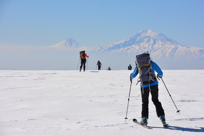 Spectacular views in the distance as skiers make their way across a flat section.