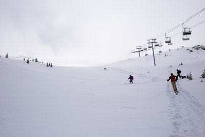 The first to climb Kachina Peak enjoy fresh April powder on Main Street, as the second group looks on from the skin track