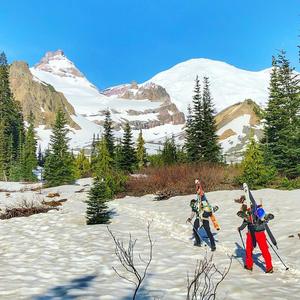 Prior to the ski transition, hiking through patchy snow with Little Tahoma and Mt. Rainier in the distance.