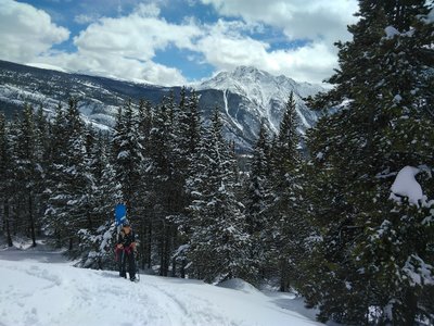 Heather hiking up coal creek trail, with Twilight Peak in the background