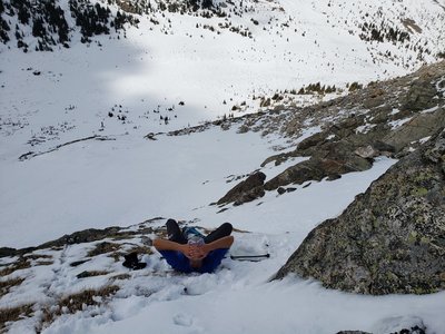 Taking a break while skirting the cliff at the base of the couloir