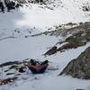 Taking a break while skirting the cliff at the base of the couloir