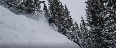 John V skiing below the rocks on the initial drop in point