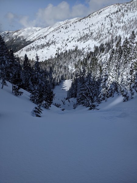 Looking down the avalanche gully on the lower NNW face of Bullion Peak. While it definitely is under overhead hazard, we thought the chute itself was fairly low angle and safe.