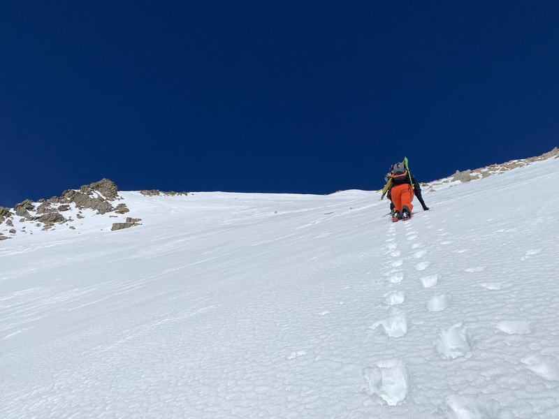 Alexis following the bootpack up the moderate angle slope.