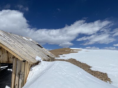 The summit is just past this old wooden building.