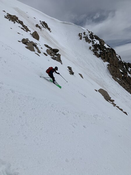 Evan skiing the line, with the small headwall behind him.