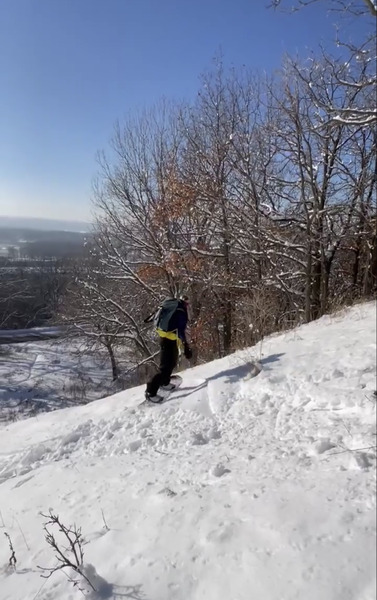 Snowboarder descending Big Wheezy at Battle Creek Park