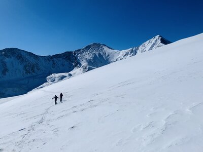 Skinning up the south slopes of Kelso Mountain, with G&T looming behind.